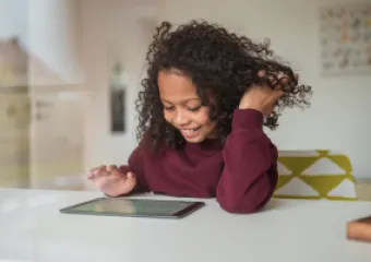 a girl playing on an ipad