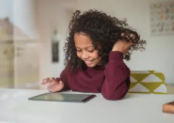 a girl playing on an tablet