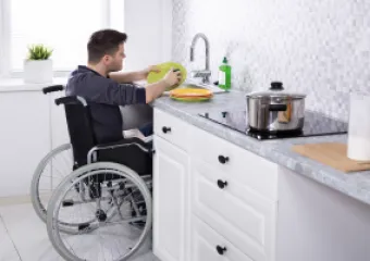 a person cooking in in a wheelchair, counters accesibles