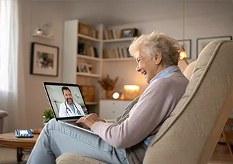 A woman talking to a doctor from a tablet
