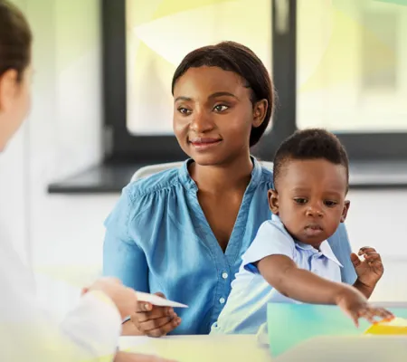 Doctor talkint to a mother and child