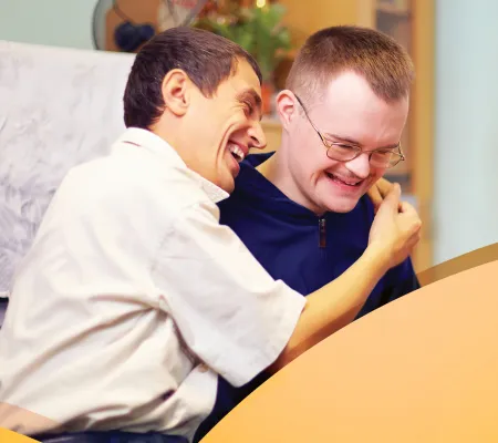 Two young men laughing and conversing