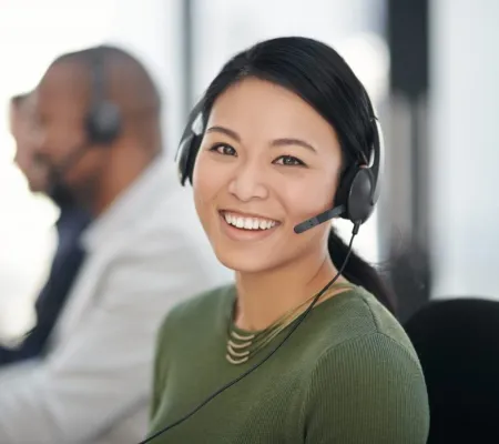 A female call center agent smiling