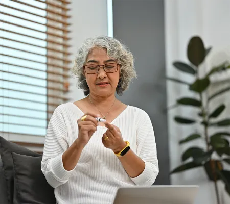 a photo of a senior woman getting a home AC1 test