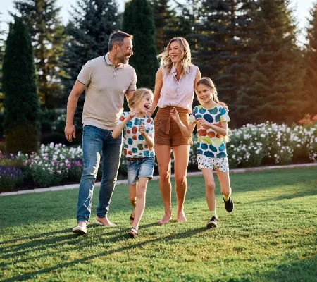 a family playing in the park with their kids.