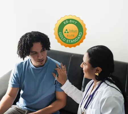 A doctor talking to a patient the Seal fo Gold Standard on the background