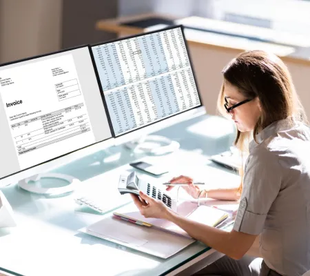 A woman infront a computer working in accounting