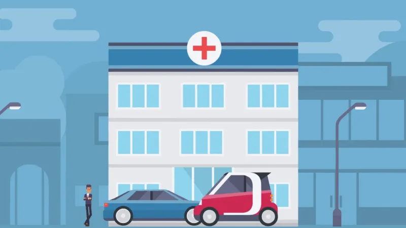 An image of a hospital with two cars drinving in front of the entrance