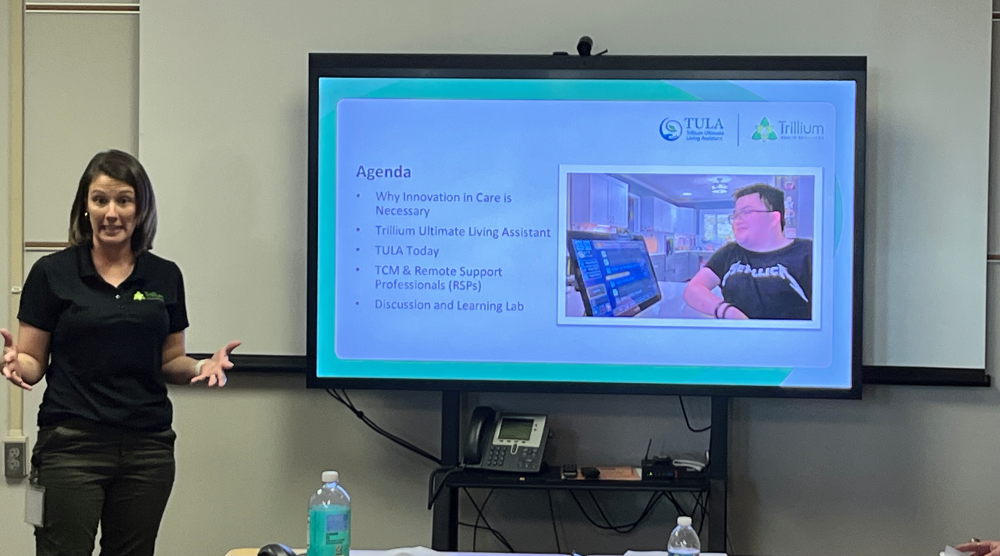 a woman infront of an audience presenting TULA