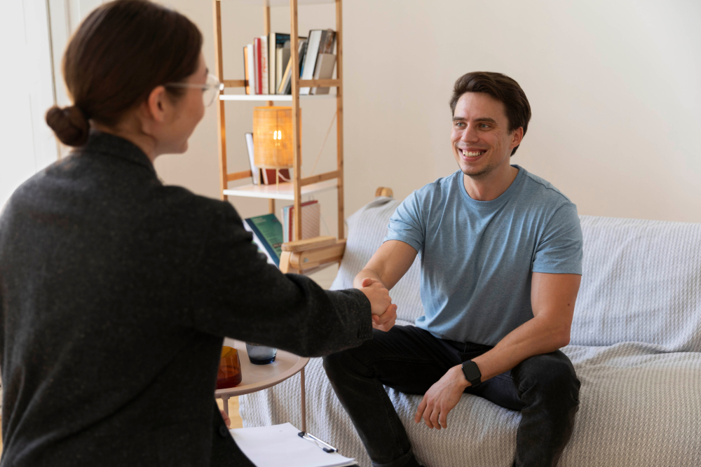 A young man with a therapits in a living room