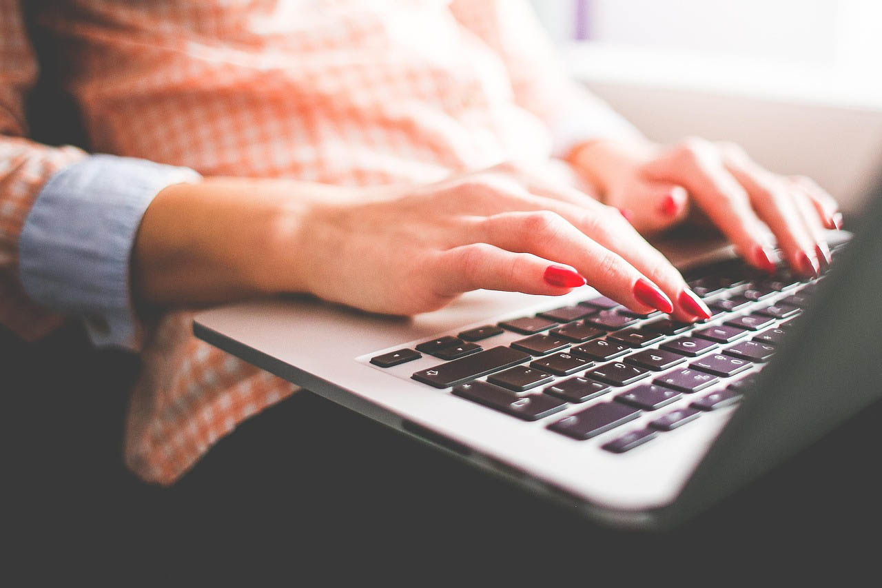 Photo of a hand typing in a laptop