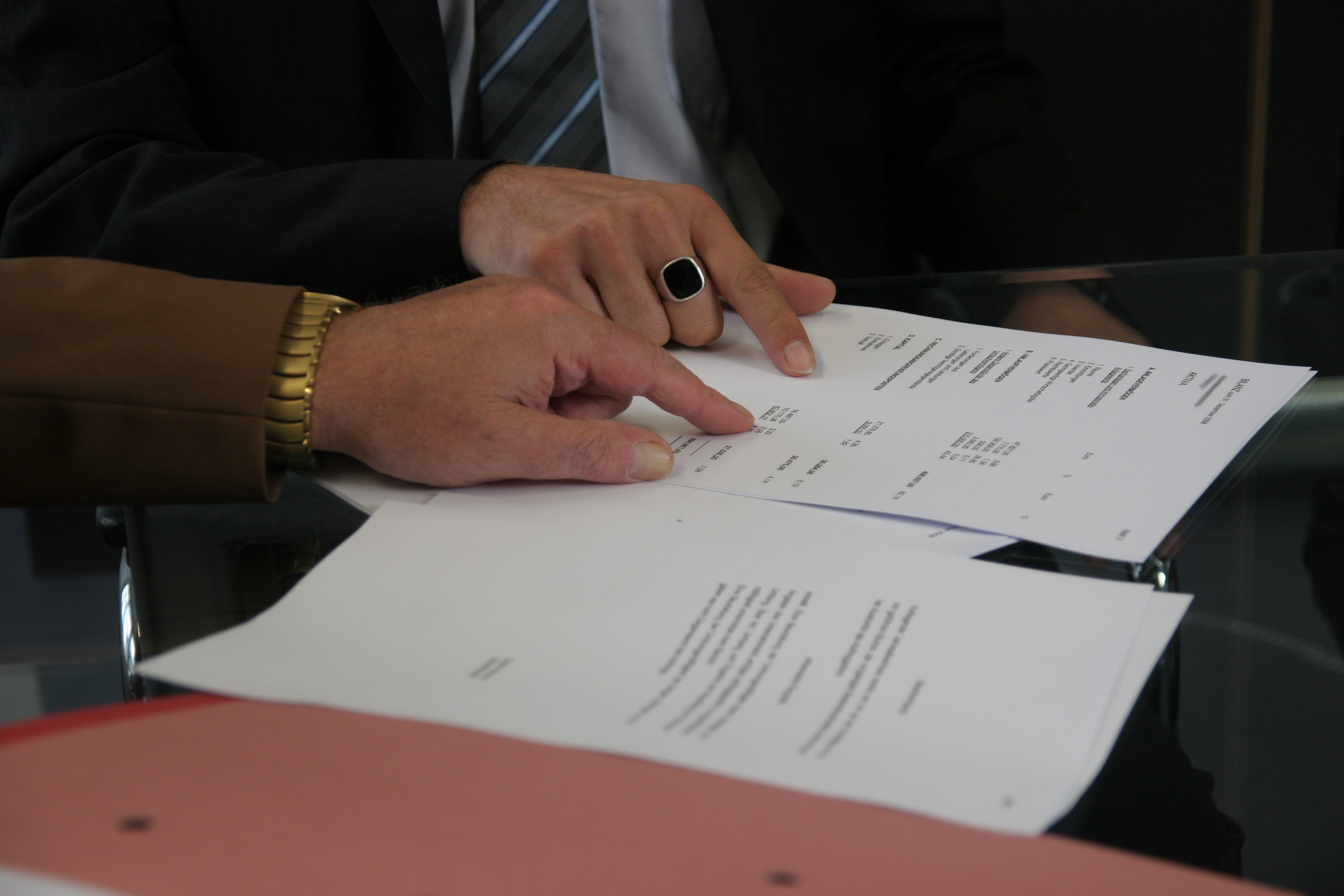 Two hands, a woman and man hands checking paperwork