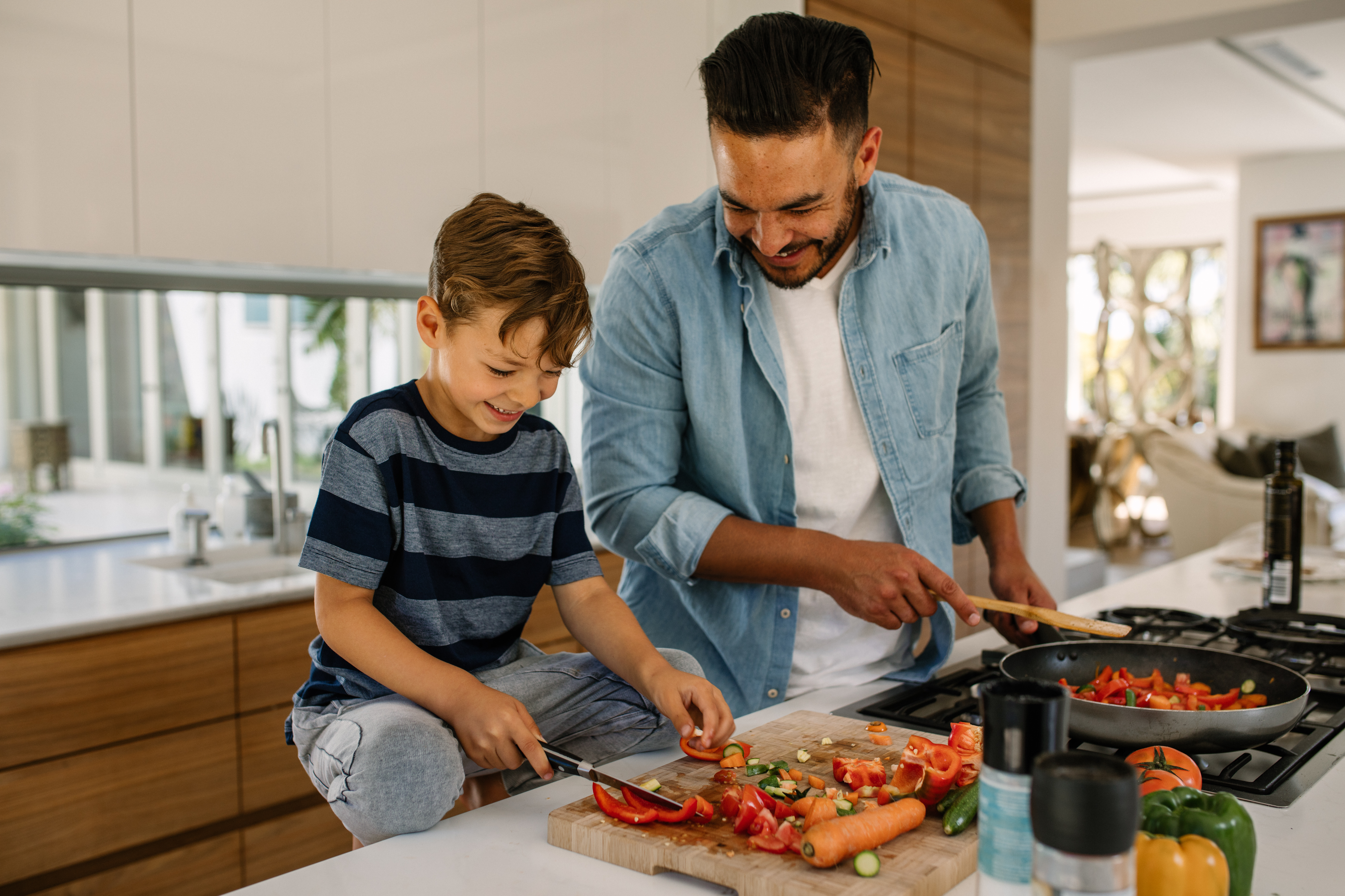 father a son cooking together