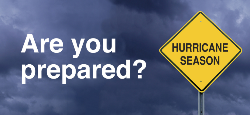A cloudy sky, yellow sign with the message Hurricane Season