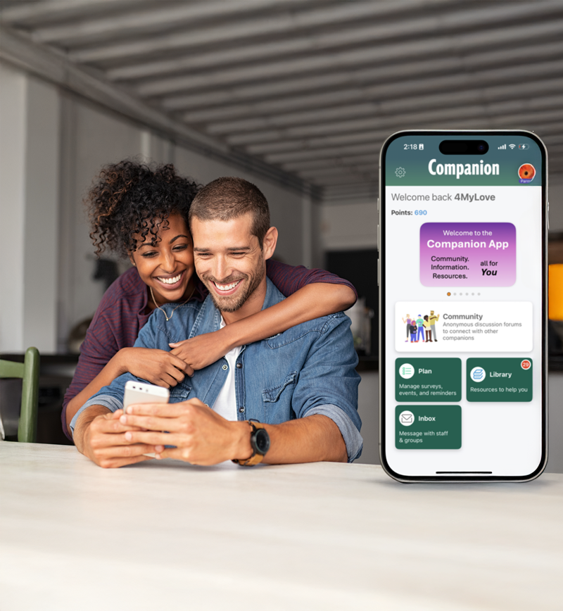 A couple looking at a mobile phone with the app Companion