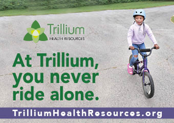 A kid riding a bicicle on the road