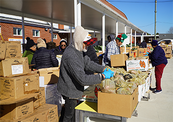 A group of people giving box of good