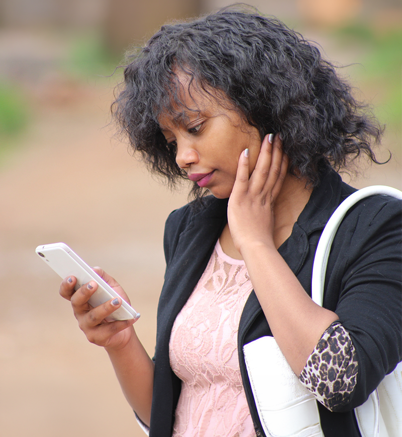 a photo of a woman looking at her cellphone